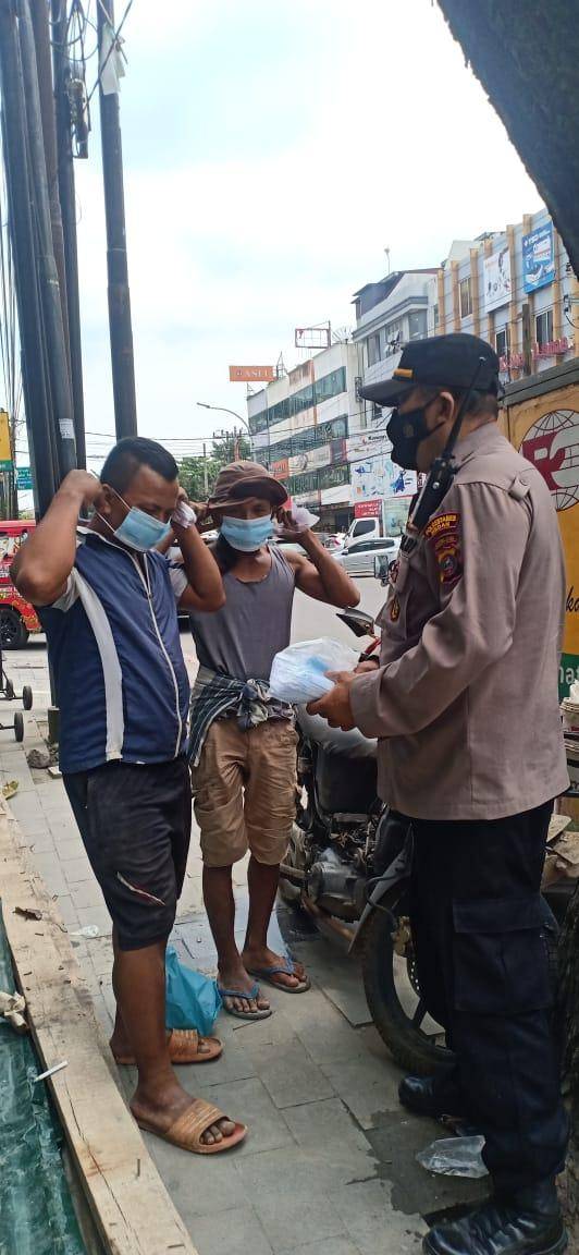 Kepada Warga Pengguna Jalan, Kanit Binmas Polsek Medan Baru Bagikan Masker