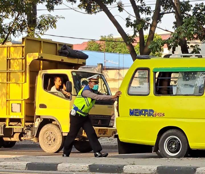 Salut, Seorang Polisi Lalu Lintas di Medan Dorong Angkot Mogok di Tengah Padatnya Kenderaan