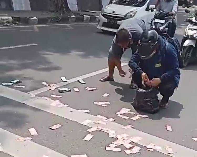 Plastik Robek Uang Seratus Ribu Berjatuhan di Jalan Imam Bonjol